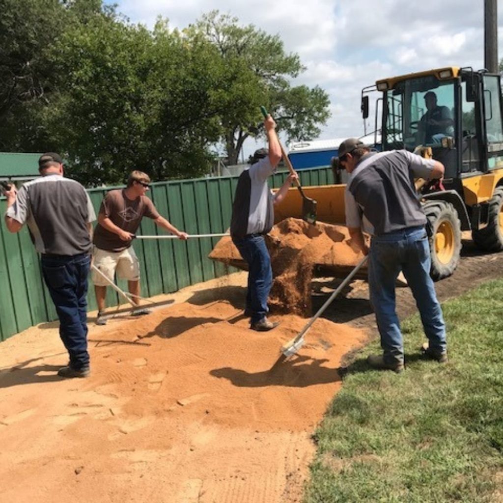 C & B Corsica helped extend the warning track in the out-field at their local baseball field.